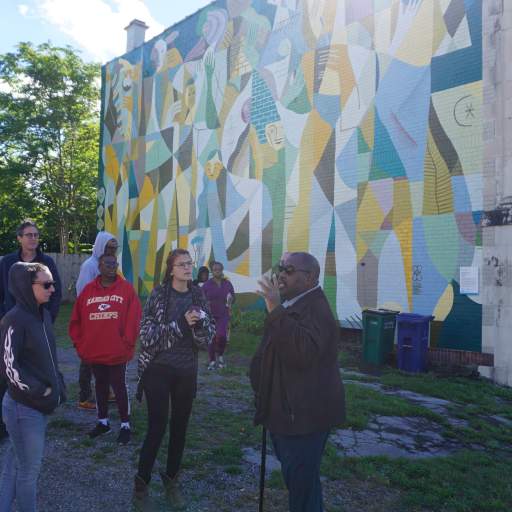 Emerging Leaders in front of Work and Play mural in the Broadway-Fillmore neighborhood