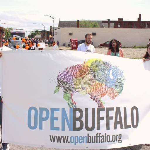 06. Carrying the Open Buffalo banner down Genesee Street.