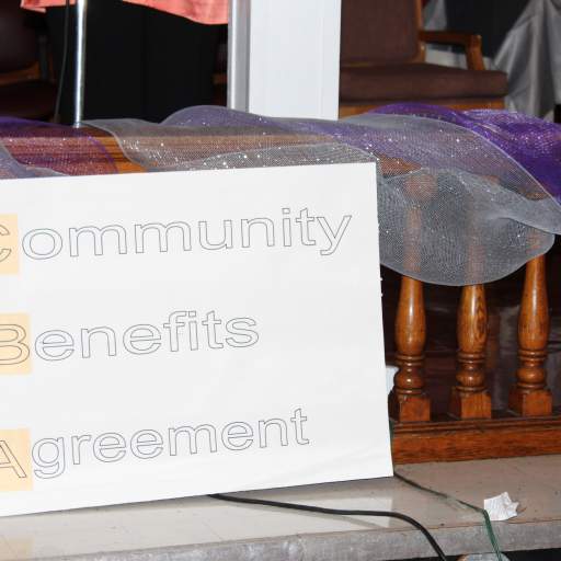 Residents displayed signs calling for broader support of a community benefits agreement to help the Fruit Belt.