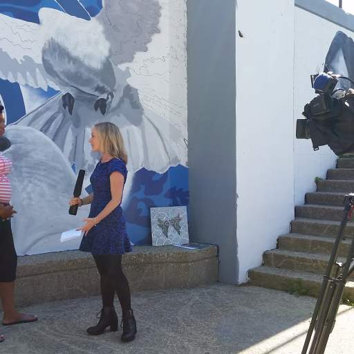 Erica Brecher of WGRZ, Channel 2, interviews Makeyia Hunt at the Ray of Light Mural site.