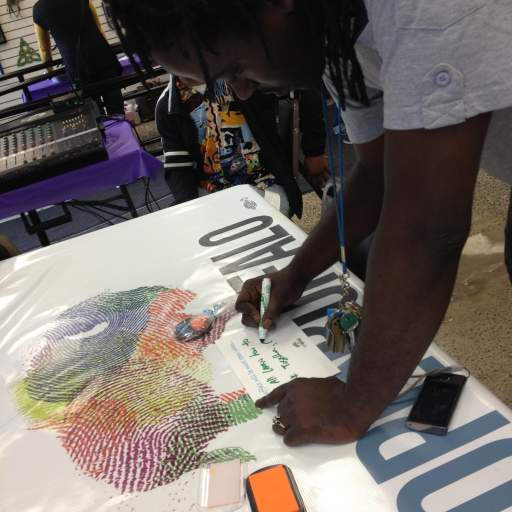 Filling out an Open When card at the West Side Bazaar.